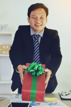 Executives give boxes to the staff and smile happily.