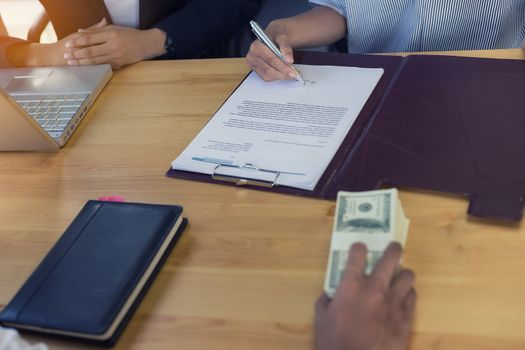 Business woman signing a loan for investment, negotiation