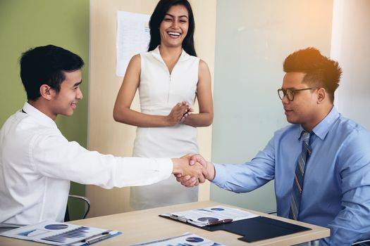 Image of a businessman joining hands after agreeing to a business deal.