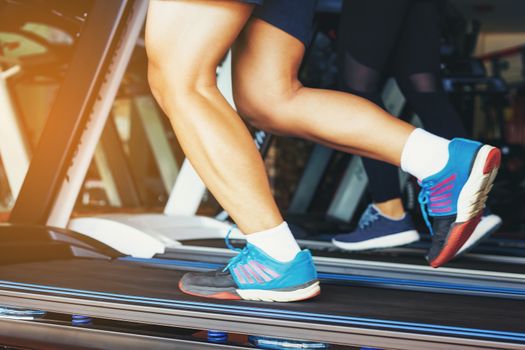 A handsome man running in the gym. The concept of jogging, fitness and a healthy lifestyle.