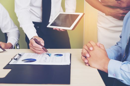 Portrait of investment agent consulting with his client while sitting at office