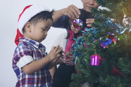 Father and son help to decorate the Christmas tree.