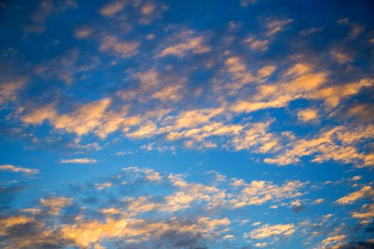 Blue sky with white clouds And the light of the sunset.