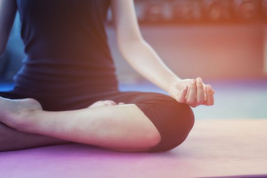 Beautiful girls exercise with yoga in public gym.