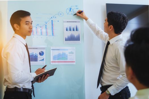 Portrait of investment agent consulting with his client while sitting at office