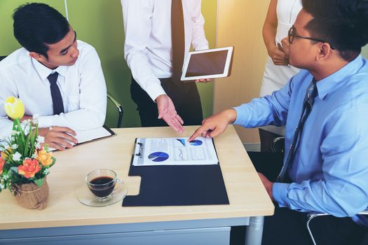 Portrait of investment agent consulting with his client while sitting at office