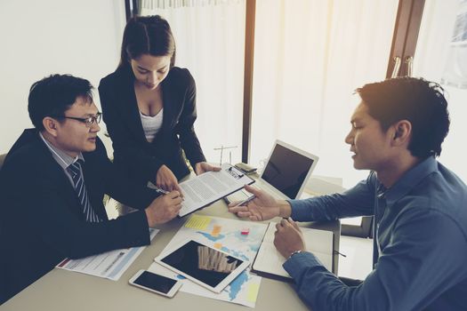 Business people are negotiating a business and signing a business agreement.