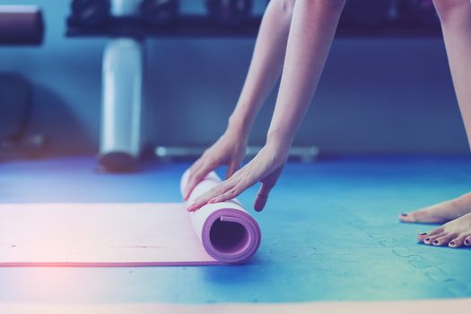 Beautiful girls exercise with yoga in public gym.