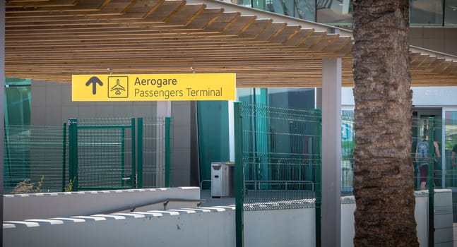 Faro, Portugal - May 3, 2018: Exterior view of Faro International Airport where passengers are walking with their suitcases on a spring day