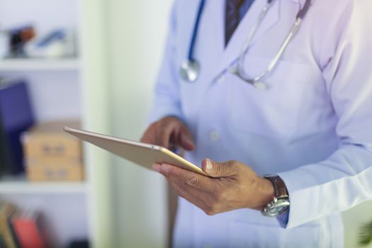 Doctor using a tablet contact with patient. Concepts of technology communication. Medical physician doctor man over clinic background. Doctor.