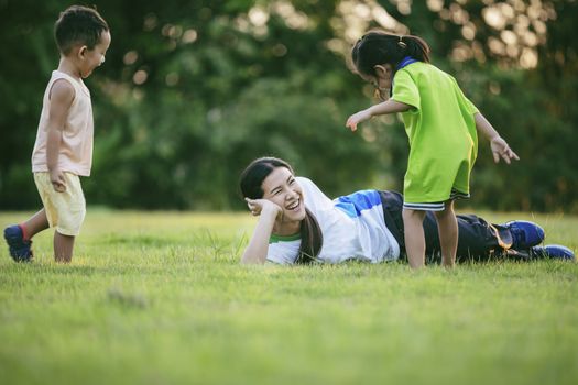 Happy family playing in the park. Mother and son play together in nature in the summer