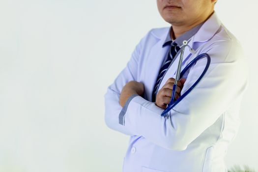 Portrait of doctor standing in his private clinic. Medical physician doctor man over clinic background. Doctor.