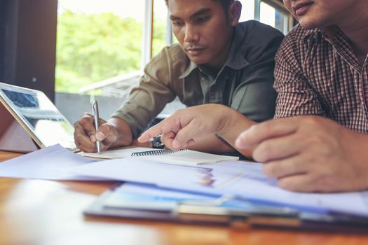 Financial planning Business man talking to planner financial business, report finance in paper on office accounting desk.