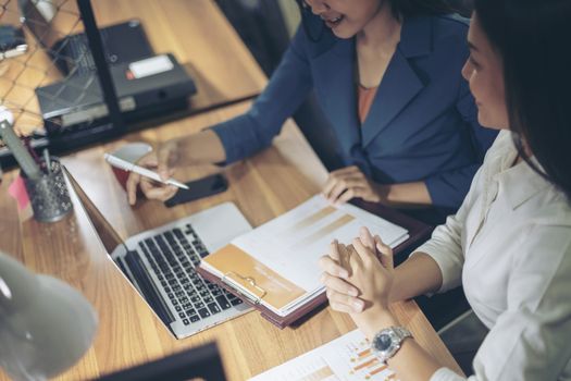 Businessman giving presentation on paper charts to colleagues in office. Business meeting time. Idea presentation, analyze plans.