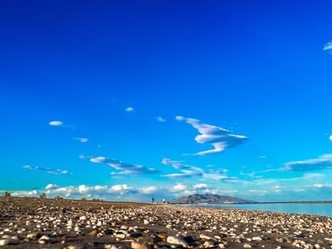 Perspective of Sandy beach with little stone. Blue turqoise waters in spanish coasts