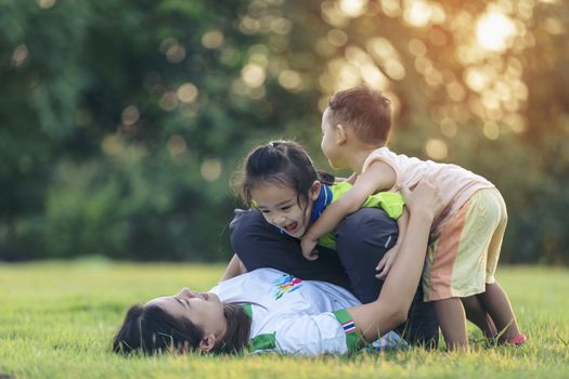 Happy family playing in the park. Mother and son play together in nature in the summer