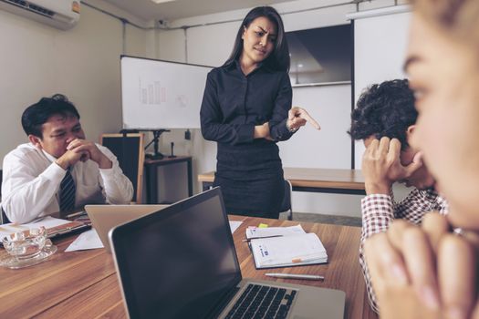 Business people are brainstorming to plan their business operations. Asian business woman leader presenting work to mixed race colleagues in the meeting