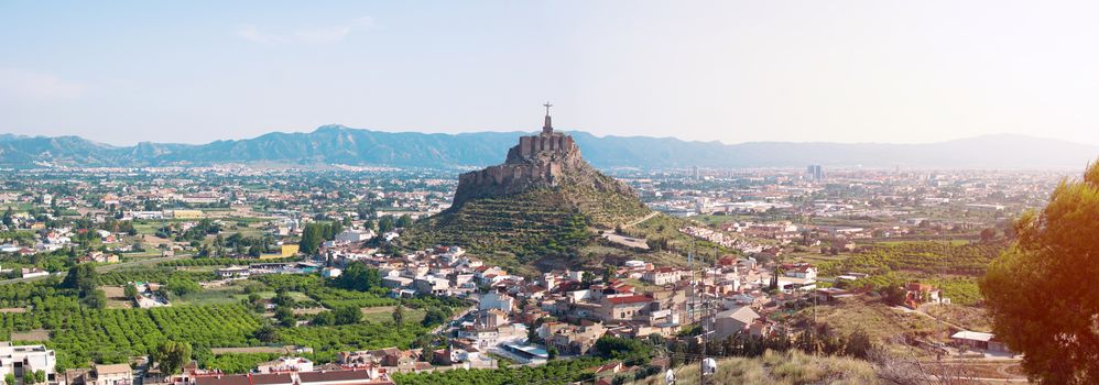 Panoramic view of Monteagudo Christ statue and castle at sunset in Murcia, Spain. Replica of the well-known Christ located on the top of the Concorvado Mountain in Rio de Janeiro.