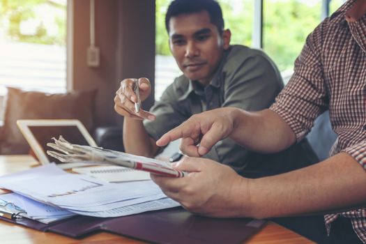 Financial planning Business man talking to planner financial business, report finance in paper on office accounting desk.