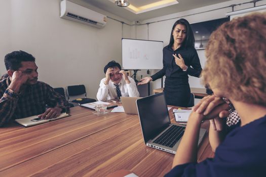 Business people are brainstorming to plan their business operations. Asian business woman leader presenting work to mixed race colleagues in the meeting