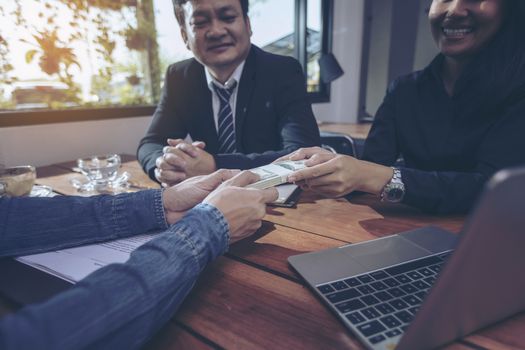 Happy smiling businessmen handshaking after signing contract meeting with businesswoman, sealing closing deal with satisfied client, bank customers come to negotiate a loan to invest.