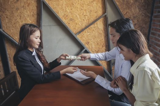 Businesspeople and partners shaking hands over the table, maintaining eye contact, confident entrepreneurs ready for effective negotiations, entering into a partnership, gender equality