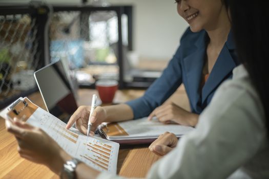 Businessman giving presentation on paper charts to colleagues in office. Business meeting time. Idea presentation, analyze plans.