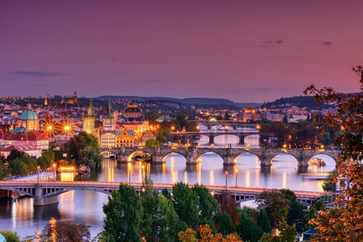 Charles bridge, Karluv most and Lesser town tower, Prague in autumn at sunrise, Czech Republic.