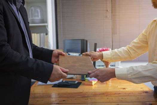 Businesspeople and partners shaking hands over the table, maintaining eye contact, confident entrepreneurs ready for effective negotiations, entering into a partnership, gender equality