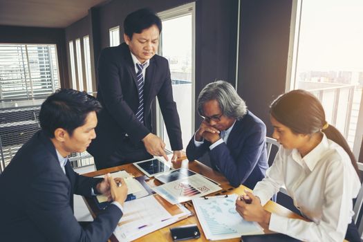 Image of business people hands working with papers at meeting. Businessman holding pens and holding graph paper are meeting to plan sales to meet targets set in next year.