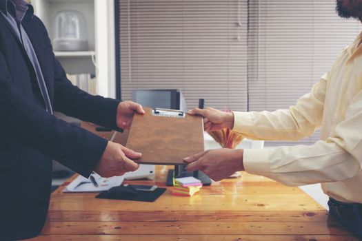 Businesspeople and partners shaking hands over the table, maintaining eye contact, confident entrepreneurs ready for effective negotiations, entering into a partnership, gender equality