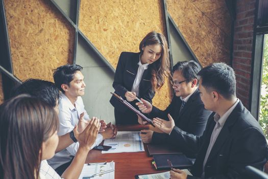 New business people are negotiating and signing a business venture agreement.