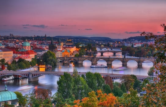 Charles bridge, Karluv most and Lesser town tower, Prague in autumn at sunrise, Czech Republic.