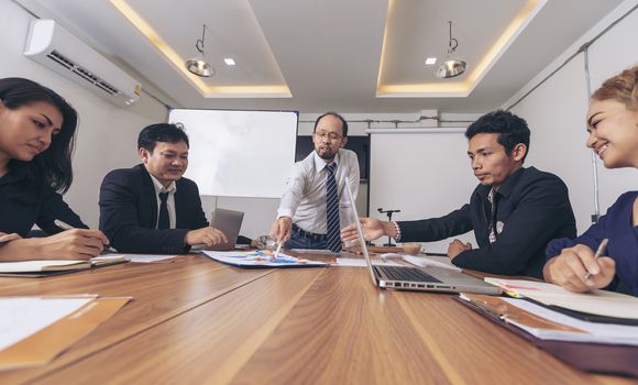 Business leader presenting new project. Businessman standing and leading business presentation. Male executive putting her ideas during presentation in conference room. 