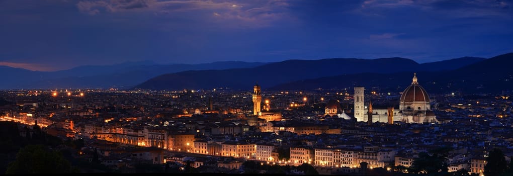 Panorama of Duomo Santa Maria Del Fiore, tower of Palazzo Vecchio and famous bridge Ponte Vecchio at night in Florence, Tuscany, Italy