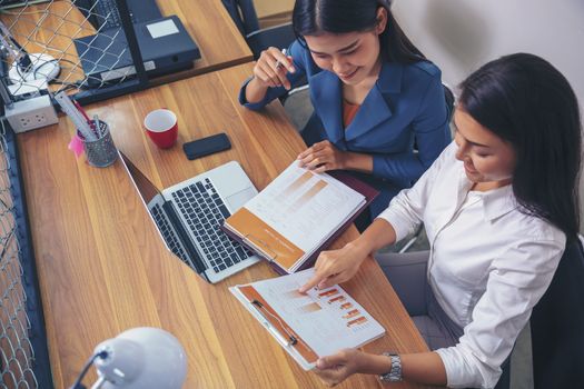 Businessman giving presentation on paper charts to colleagues in office. Business meeting time. Idea presentation, analyze plans.
