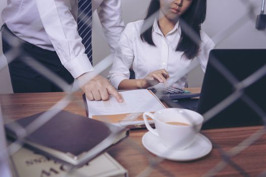 Businessman giving presentation on paper charts to colleagues in office. Business meeting time. Idea presentation, analyze plans.