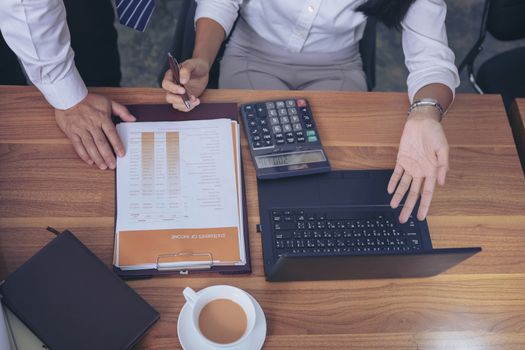 Businessman giving presentation on  computer screen to colleagues in office. Business meeting time. Idea presentation, analyze plans.