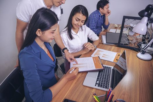 Businessman giving presentation on paper charts to colleagues in office. Business meeting time. Idea presentation, analyze plans.
