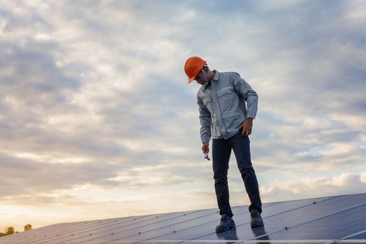 The young man is repairing the solar panel at the station.