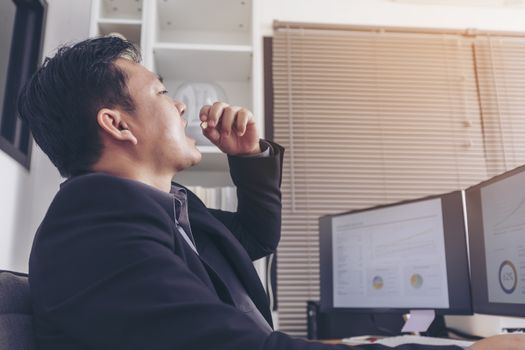 Stressed businessman having severe headache, holding painkiller remedy pill. Stress job