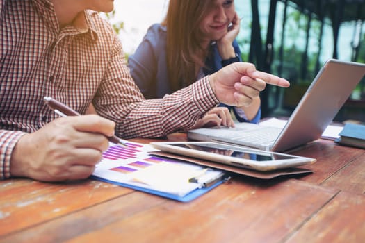 Image of two young business using computer notebook at meeting