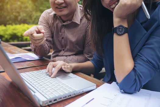 Image of two young business using computer notebook at meeting