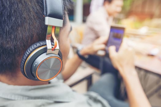 Handsome people listening to music from headphones to relax from work.