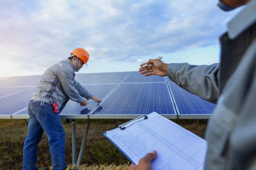 Engineers are checking the solar panel for maintenance. And clean the solar panel is always available.