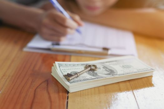 Successful business women are counting money and throwing a dollar at work happily.