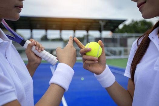 A beautiful girl is greeting each other on the tennis court before the match starts. Health Care Concept