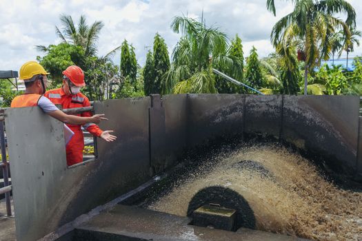 The maintenance technician is inspecting the wastewater treatment equipment of the treatment plant so that it can be operated at all times.