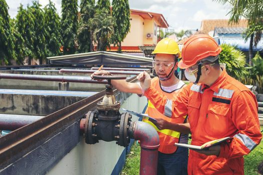 The maintenance technician is inspecting the wastewater treatment equipment of the treatment plant so that it can be operated at all times.