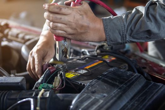 The car repairer is checking the car for maintenance. People who work on cars in the garage do their own homework. Check / inspect the engine for trouble; Diagnose and fix / fix preventative maintenance issues.